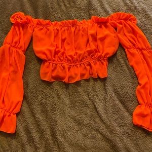 Orange long sleeve off the shoulder shirt, never worn.